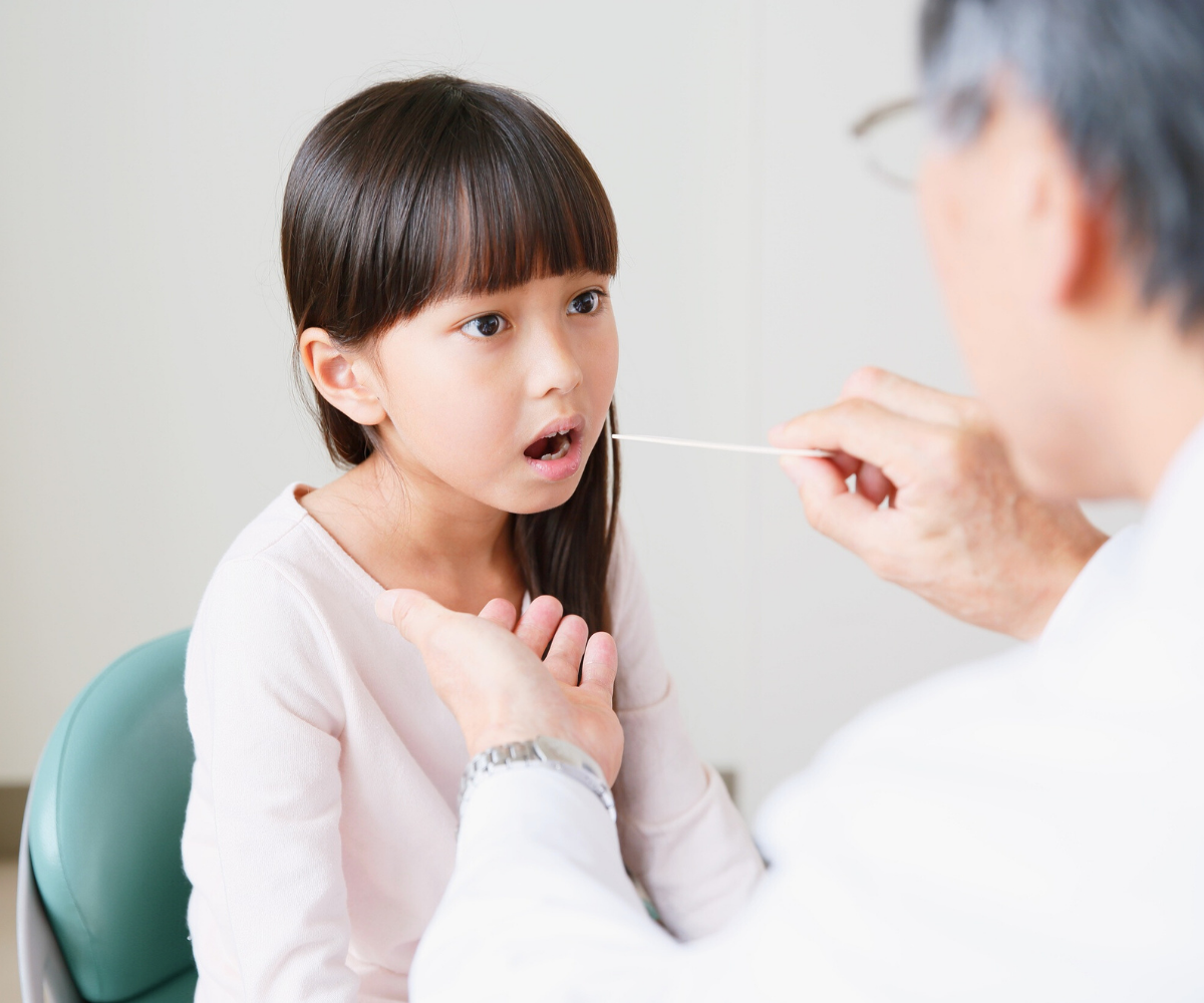 young girl getting rapid strep test